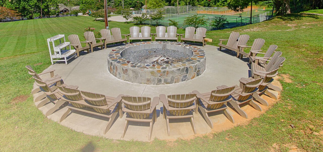 a group of chairs around a fire pit
