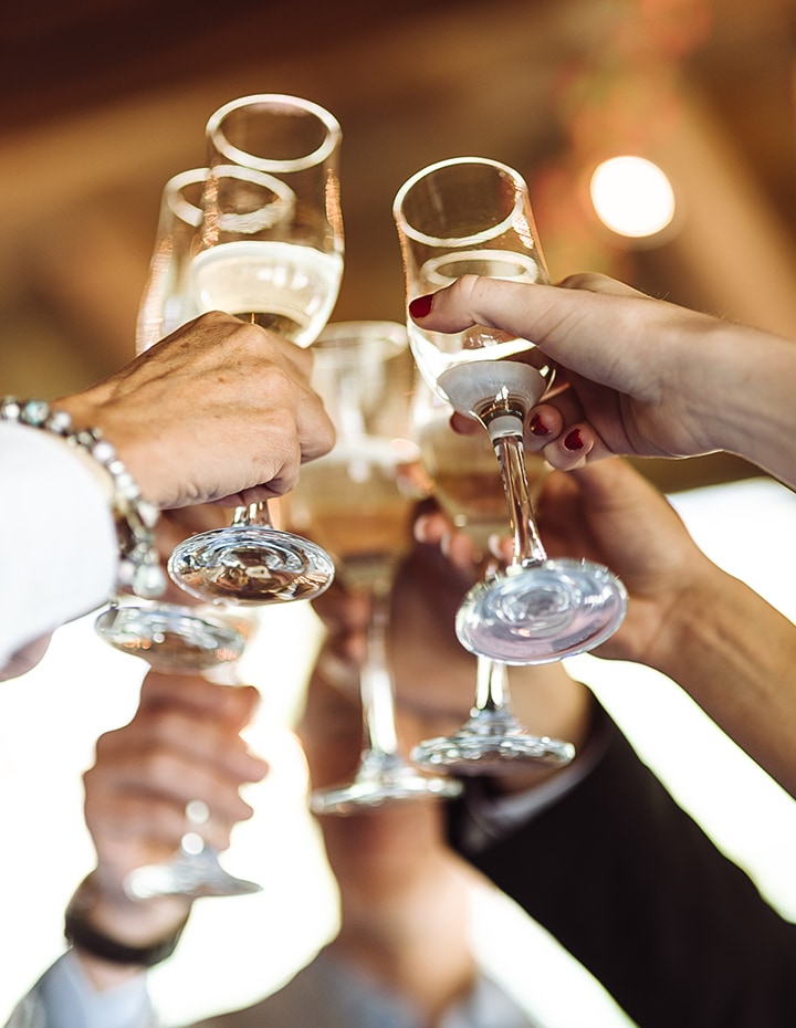 a group of people clinking champagne glasses