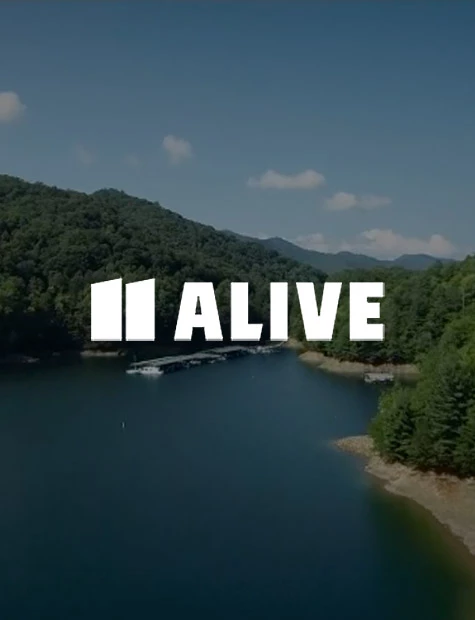 a body of water with trees around it and white text written on top