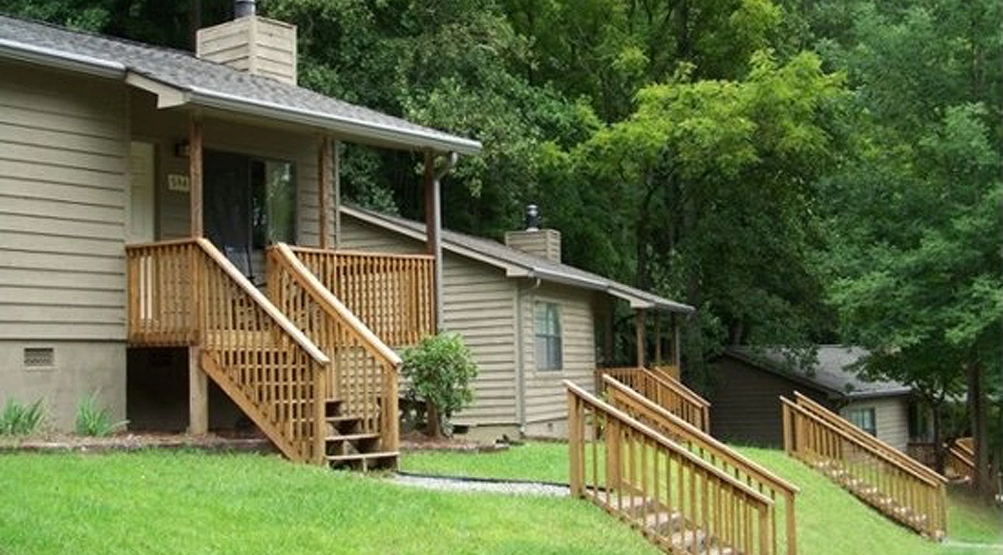 a cabin with a deck and trees