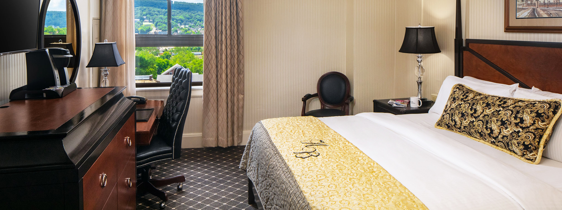 a hotel room with a bed and chairs