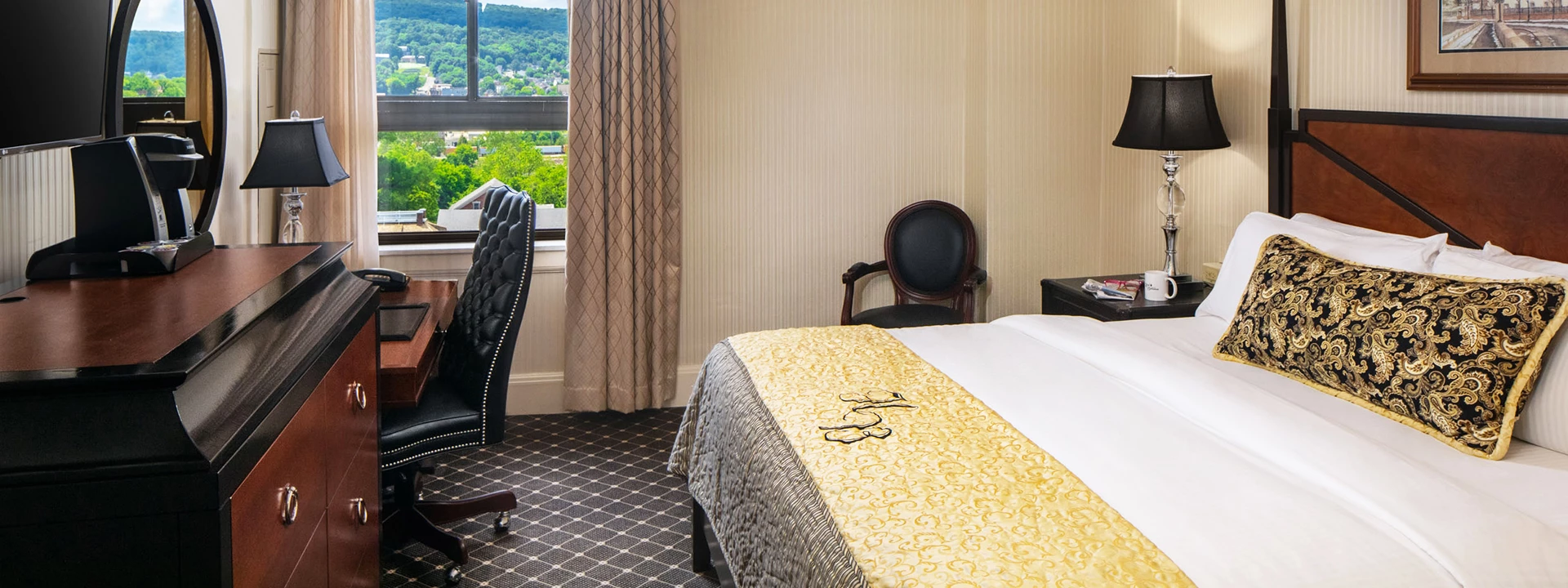 a hotel room with a bed and chairs