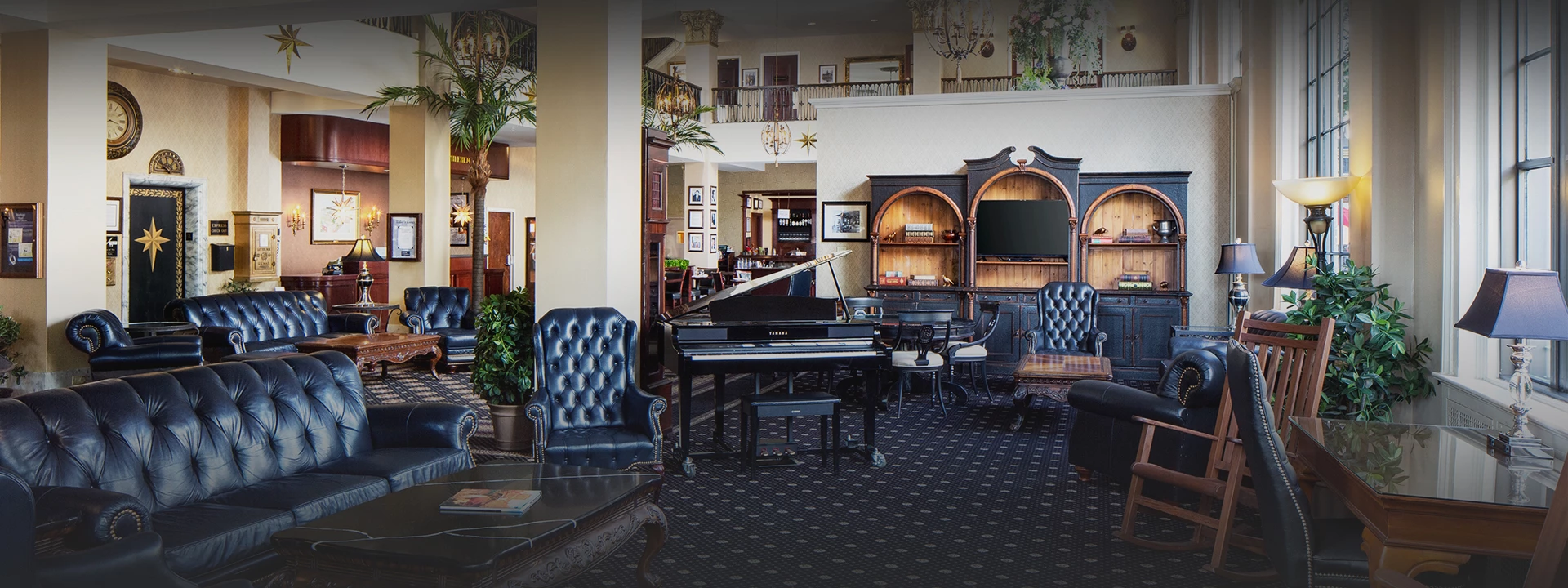 a room with a piano and chairs