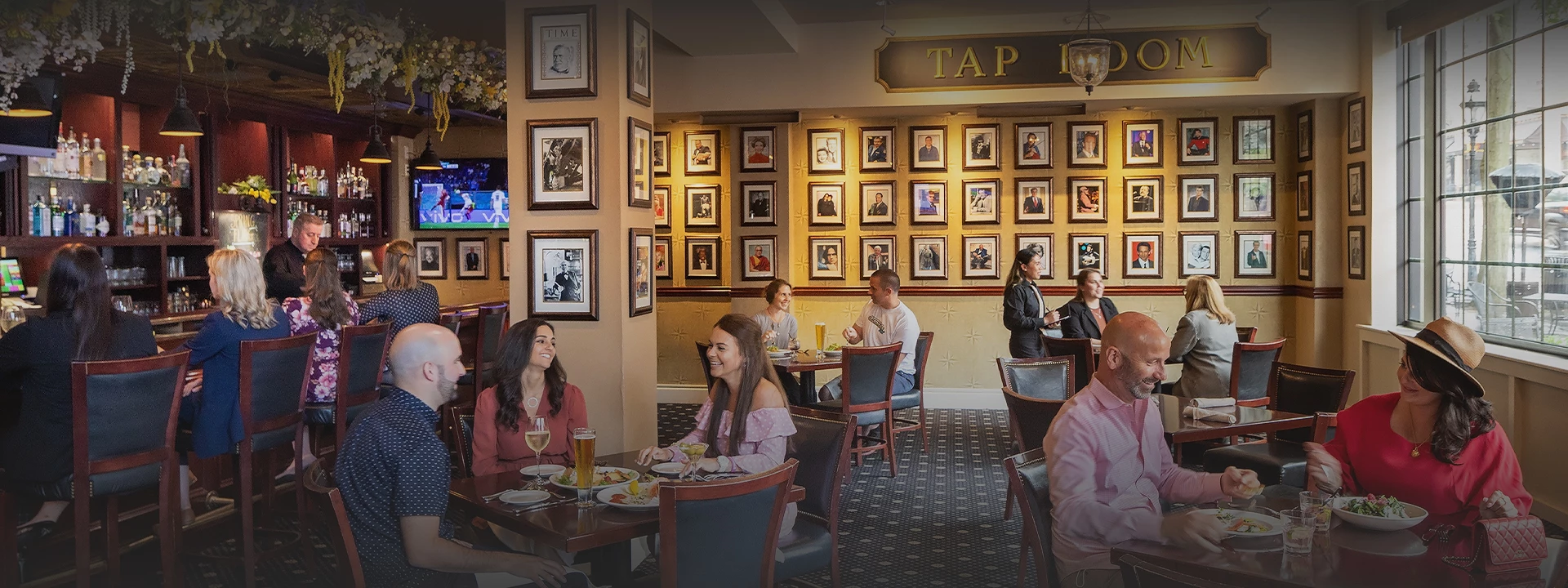 a group of people sitting at tables in a restaurant