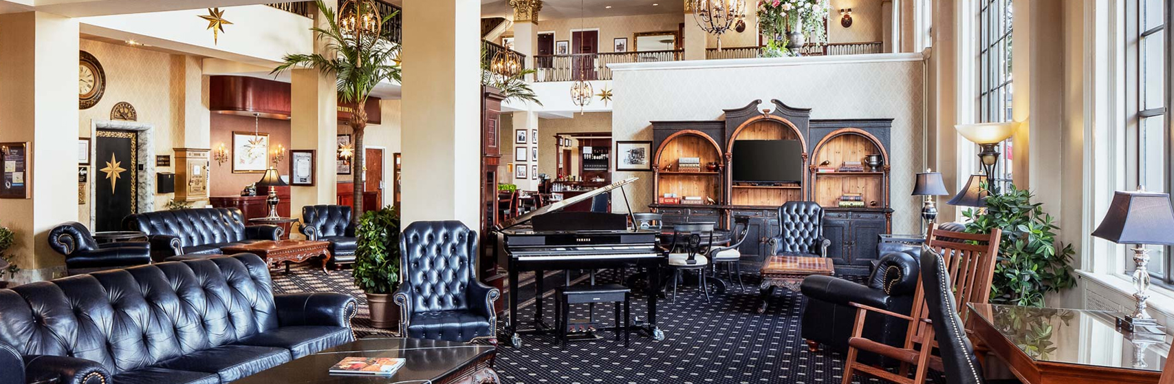 a room with a piano and chairs