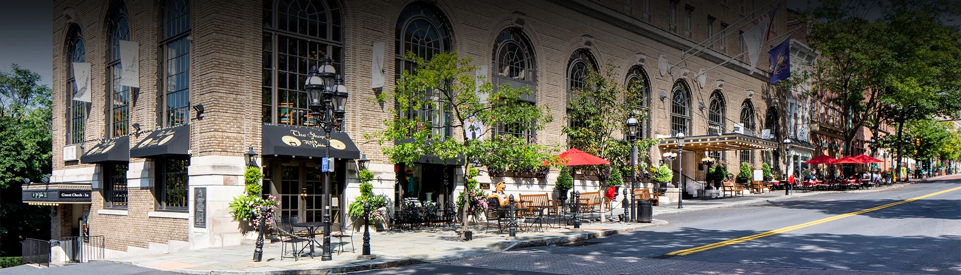 a building with a street and chairs and tables