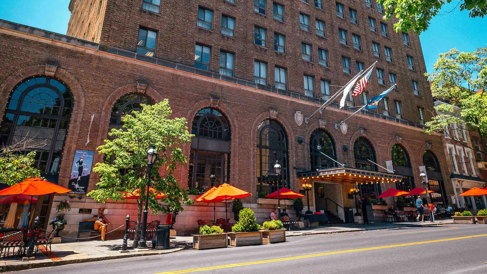 a building with flags and umbrellas
