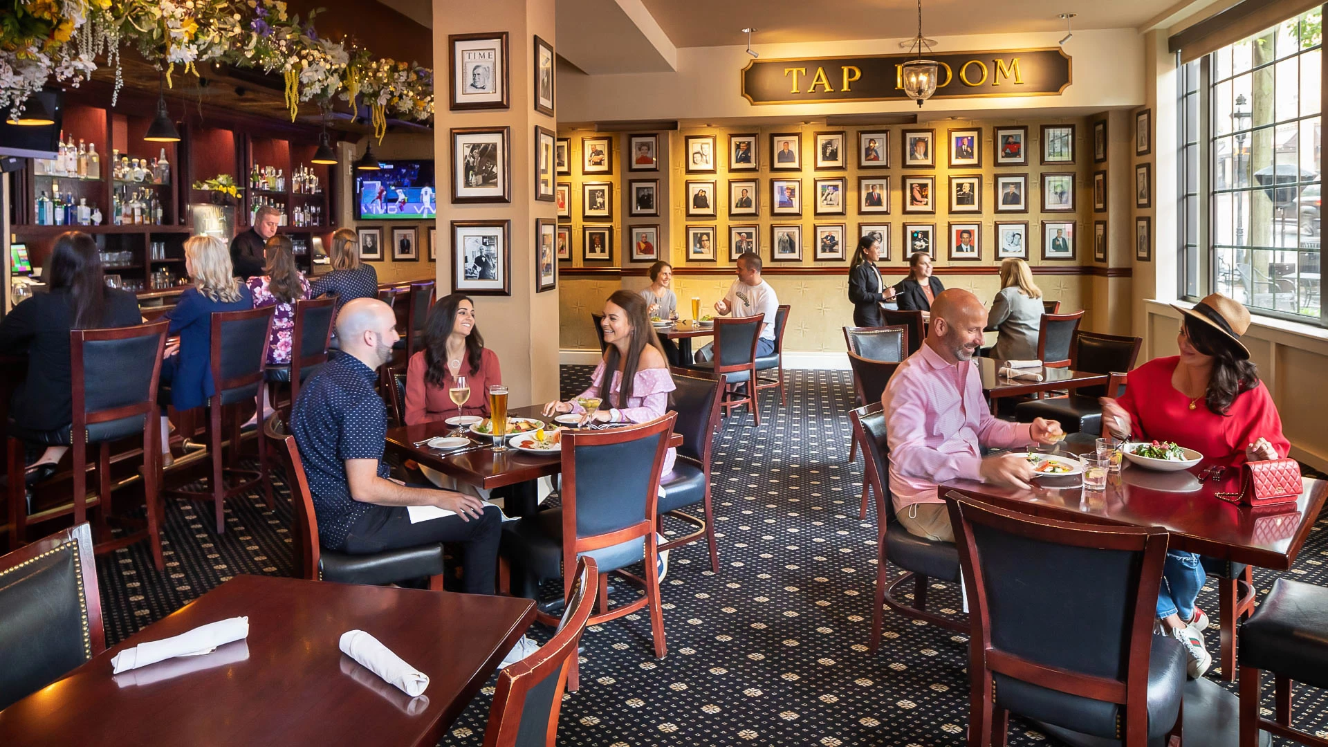 a group of people sitting at tables in a restaurant