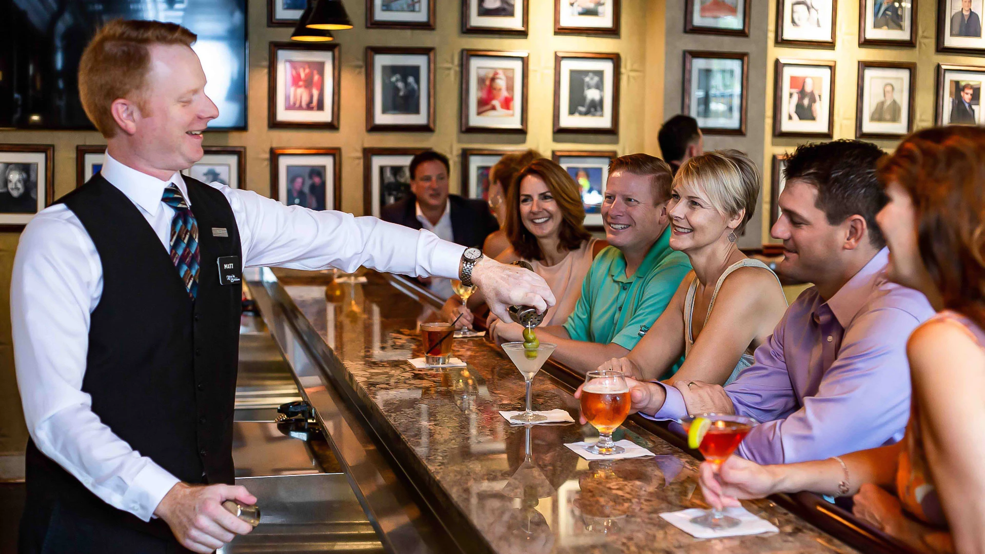 a man serving drinks to a group of people