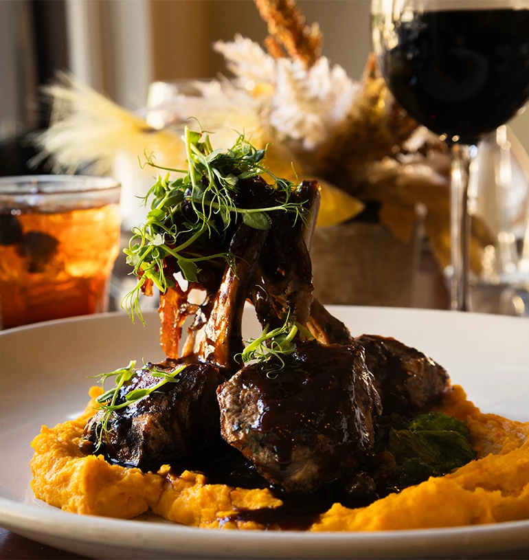 a plate of food with a glass of wine