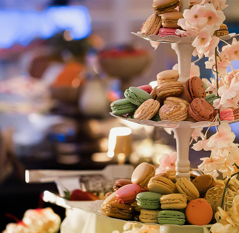 a tray of macaroons and flowers
