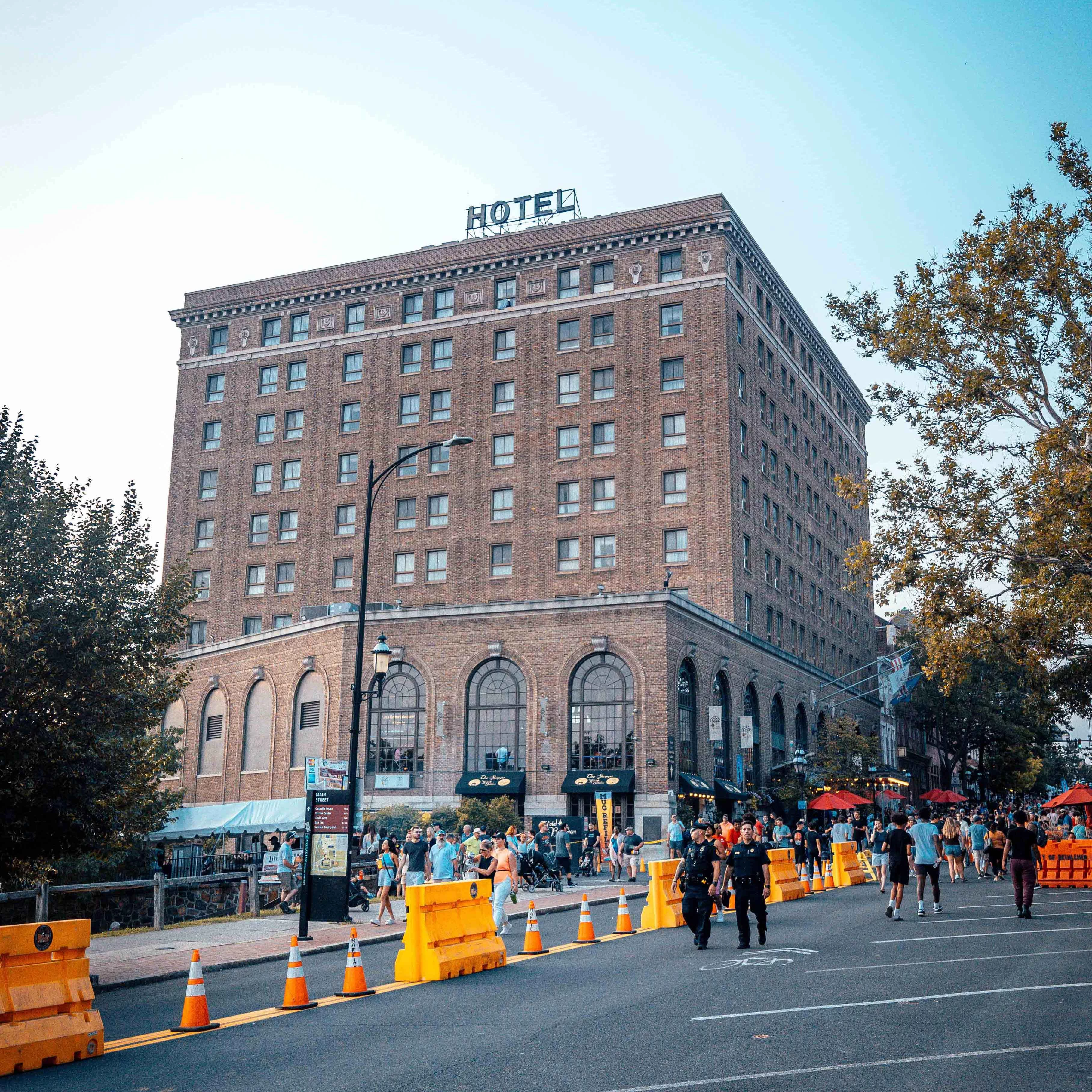 a building with many windows and people walking on the street
