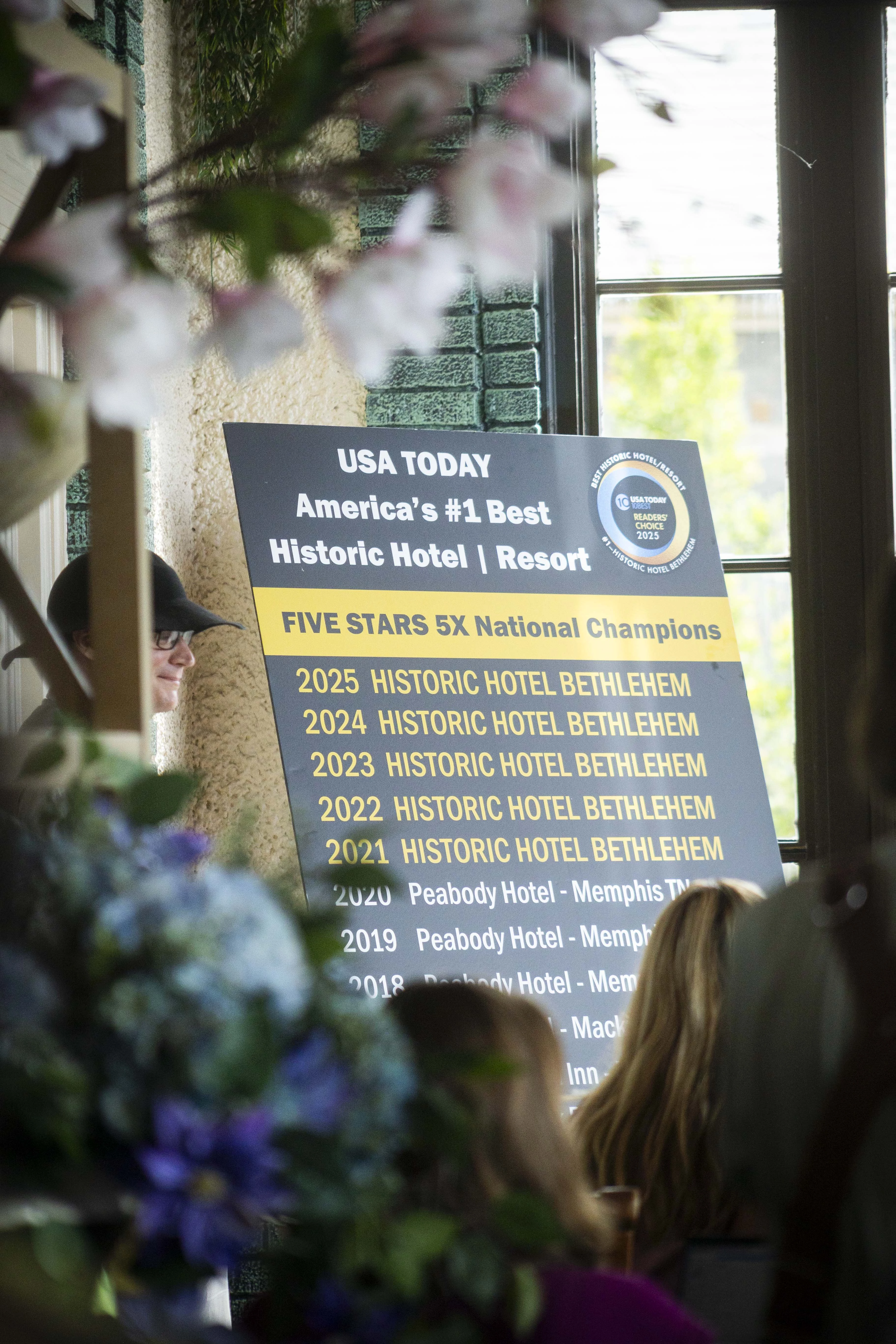 a man standing next to a sign