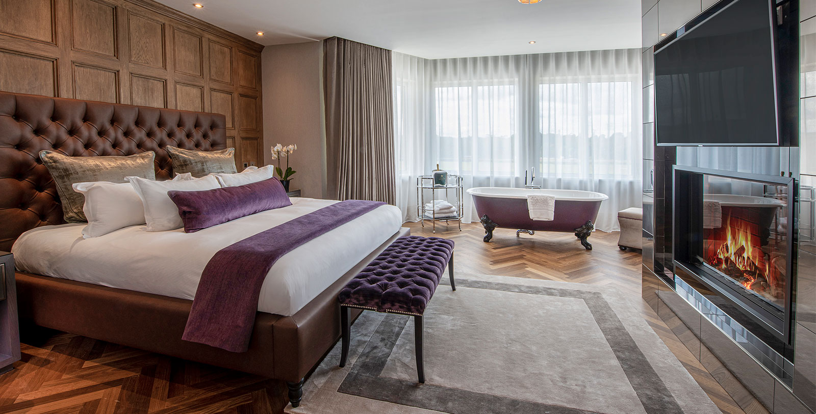a bedroom with a bathtub and a bed