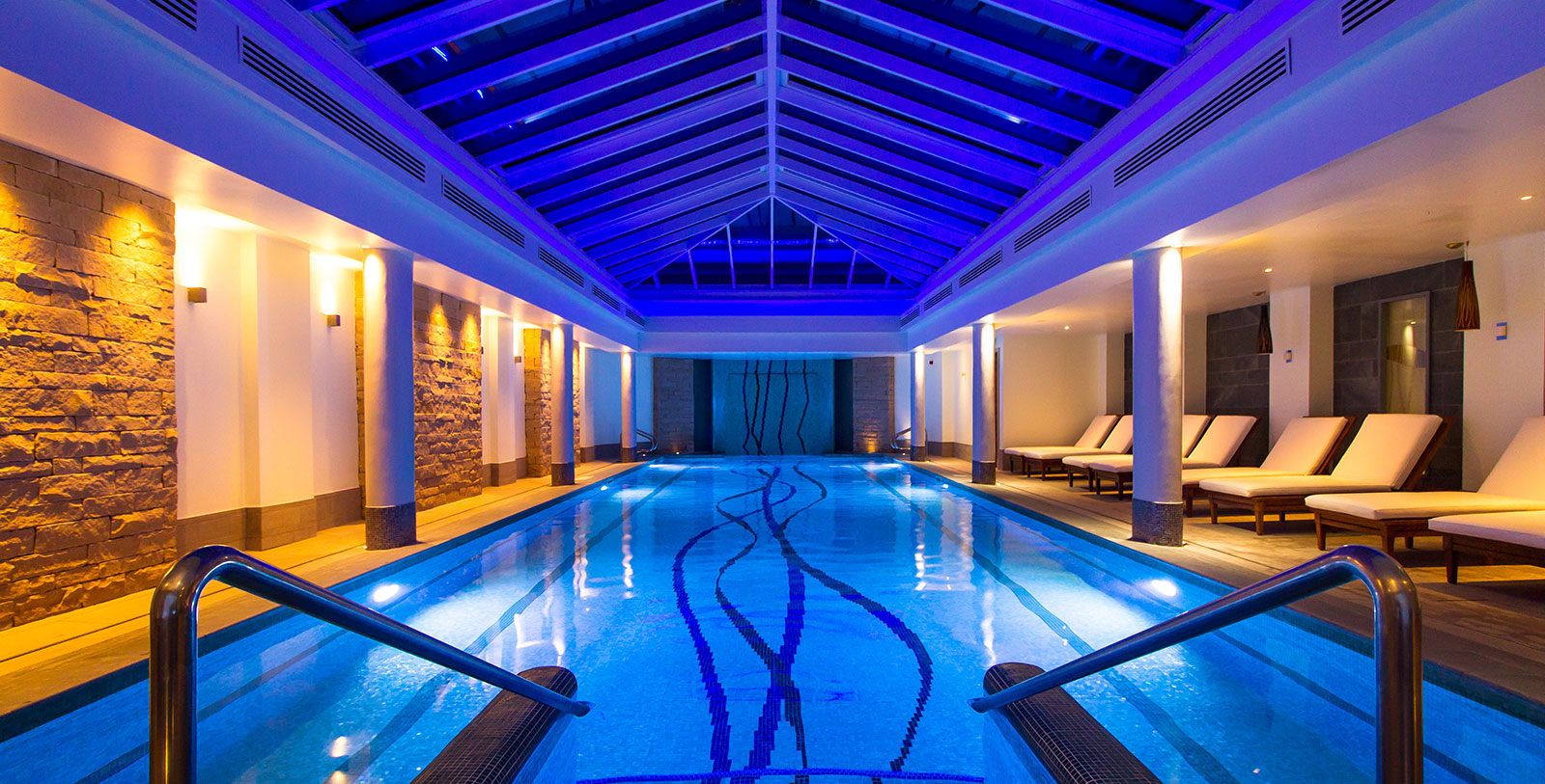 a indoor pool with a blue light