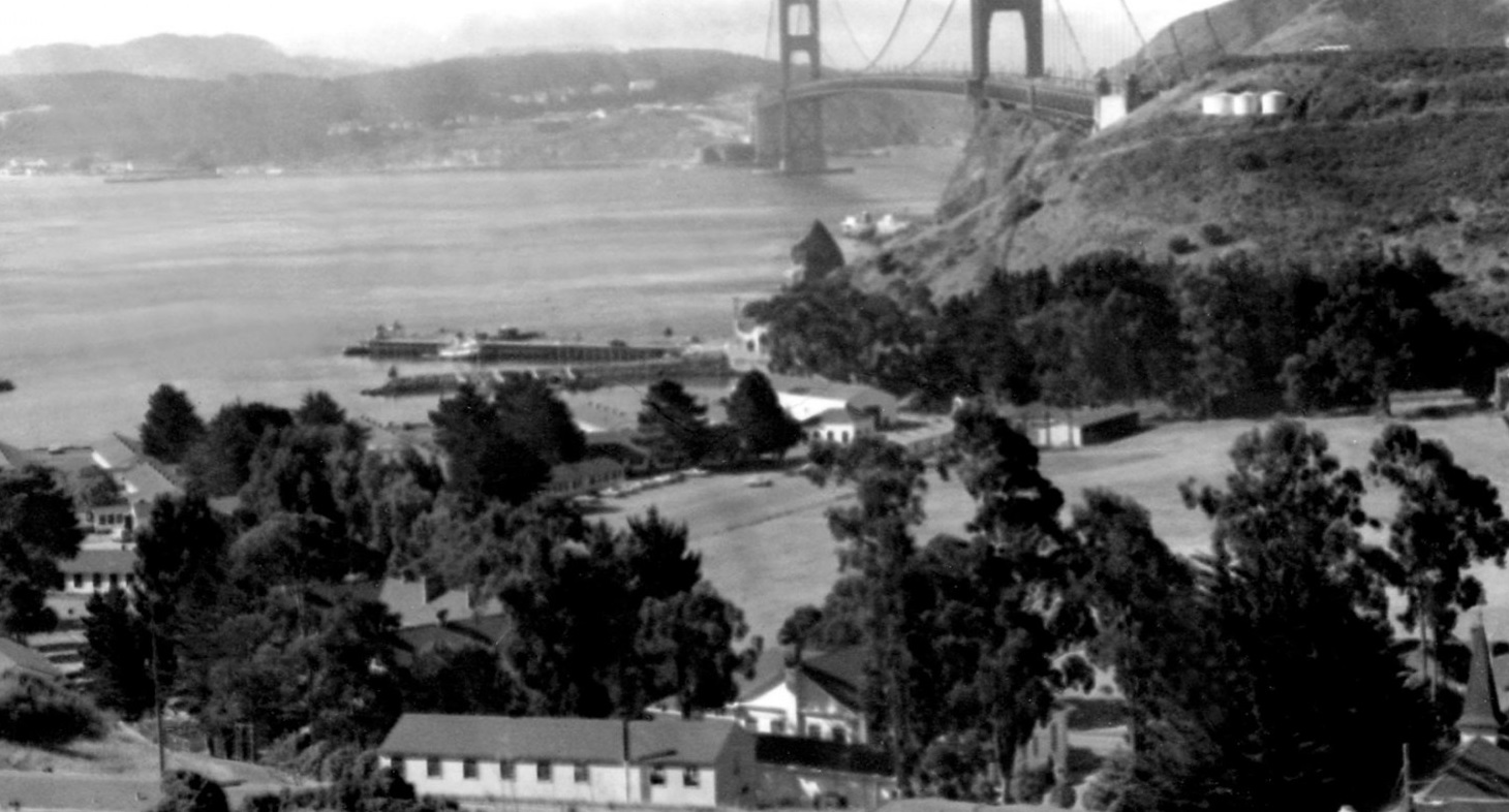 a bridge over water with houses and trees