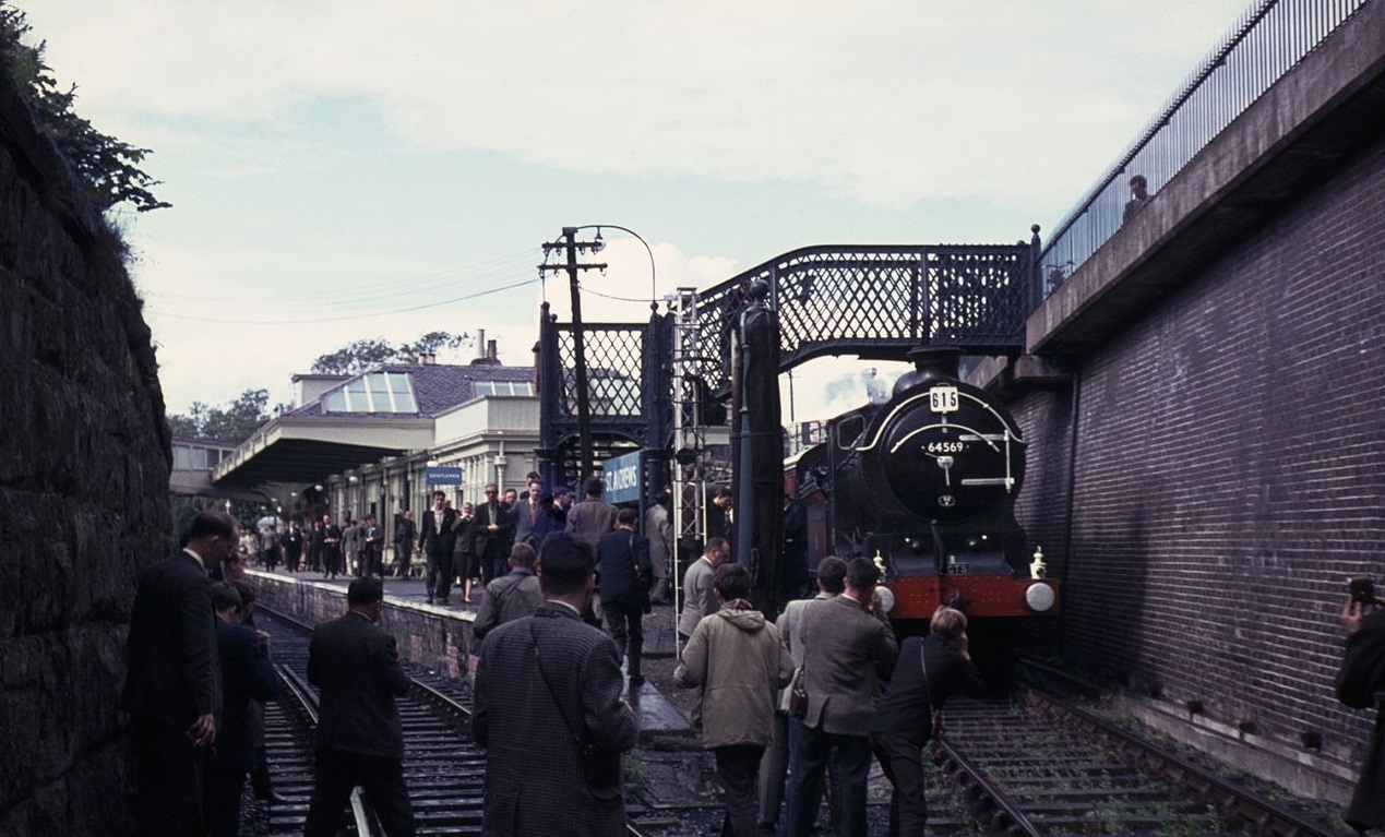 a group of people standing next to a train