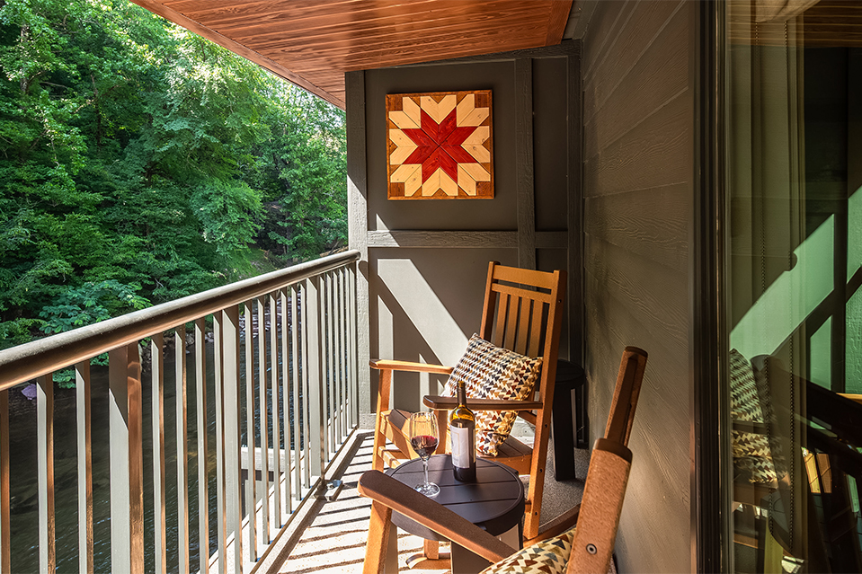 a chair and table on a balcony