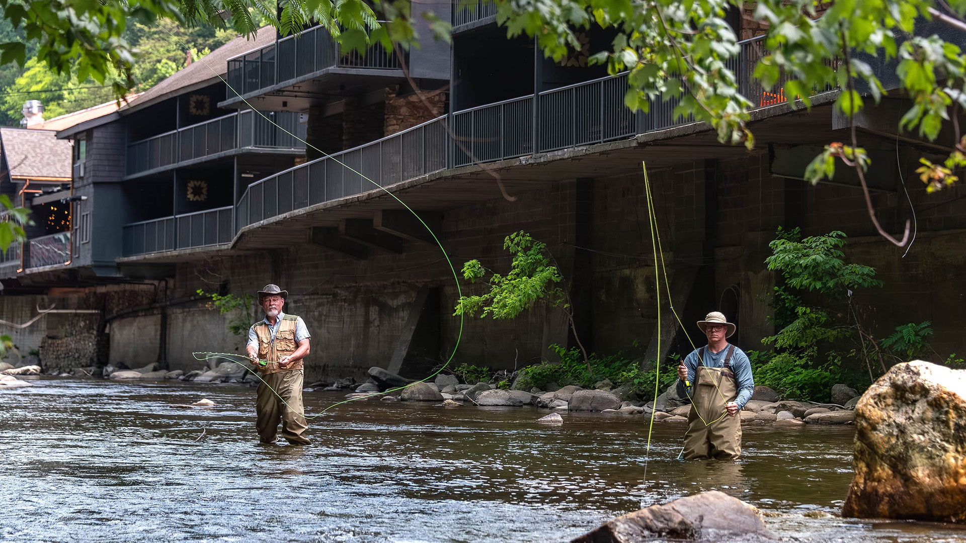 two men fishing in a river