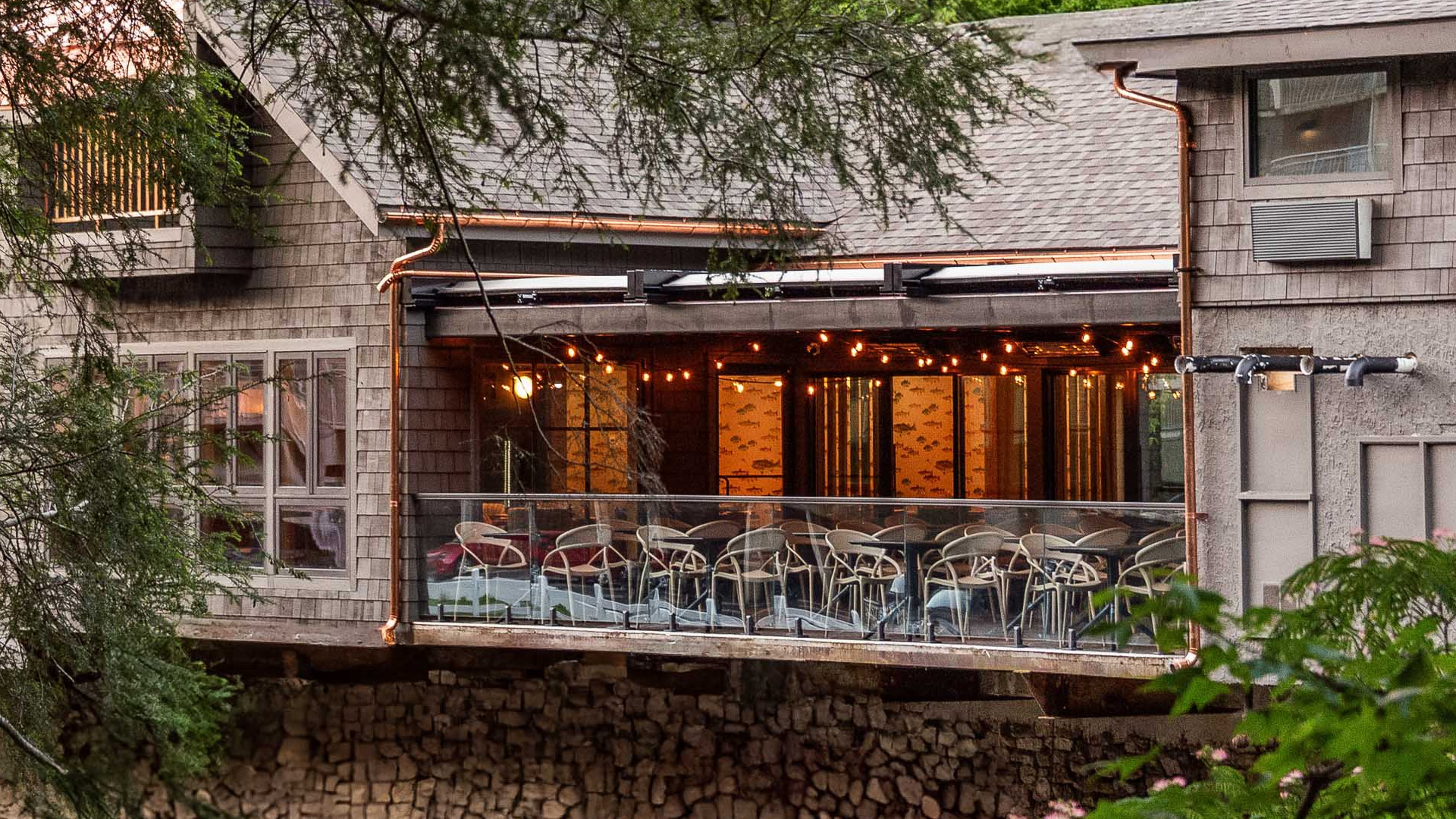a building with a glass balcony and tables