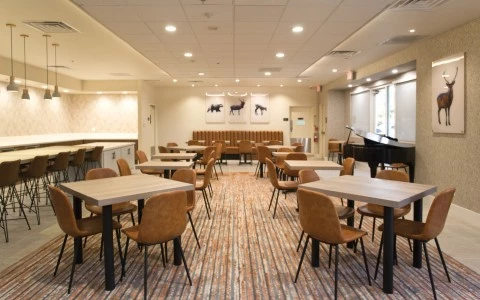 brightly lit restaurant with an assortment of chairs and tables
