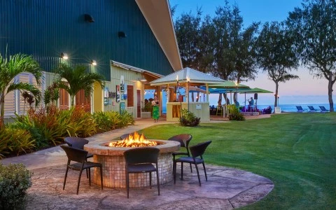 Front view of a wood fire surrounded by brown chairs, next to the hotel