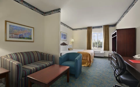 hotel suite with couch and desk