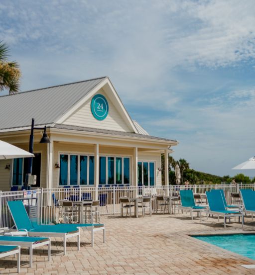 a pool and lounge chairs by a building
