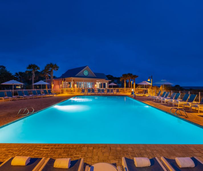 a pool with lounge chairs and umbrellas