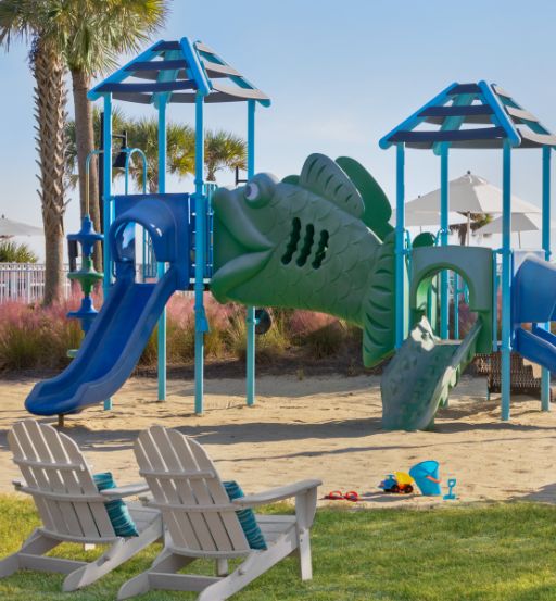 a playground with a fish and a slide