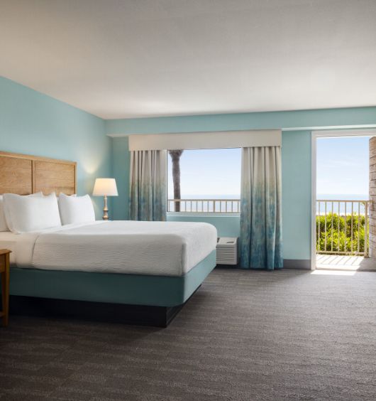 a room with a bed and a balcony