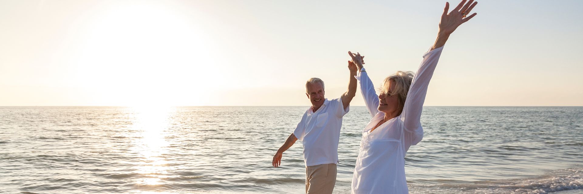 a man and woman standing on a beach