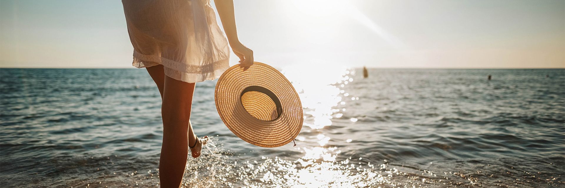 a person holding a hat in the water