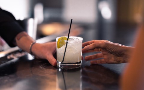 a hand reaching for a drink