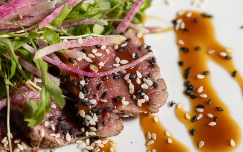 a plate of food with sauce and vegetables
