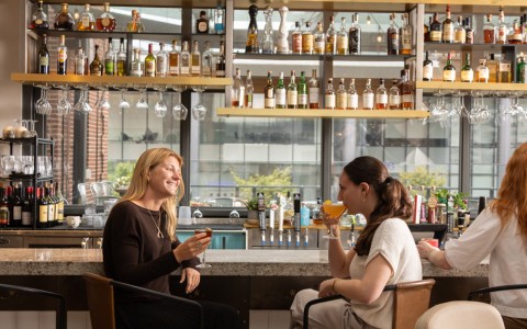 a group of women sitting at a bar