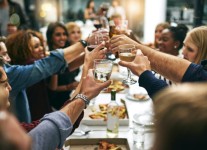 a group of people clinking glasses