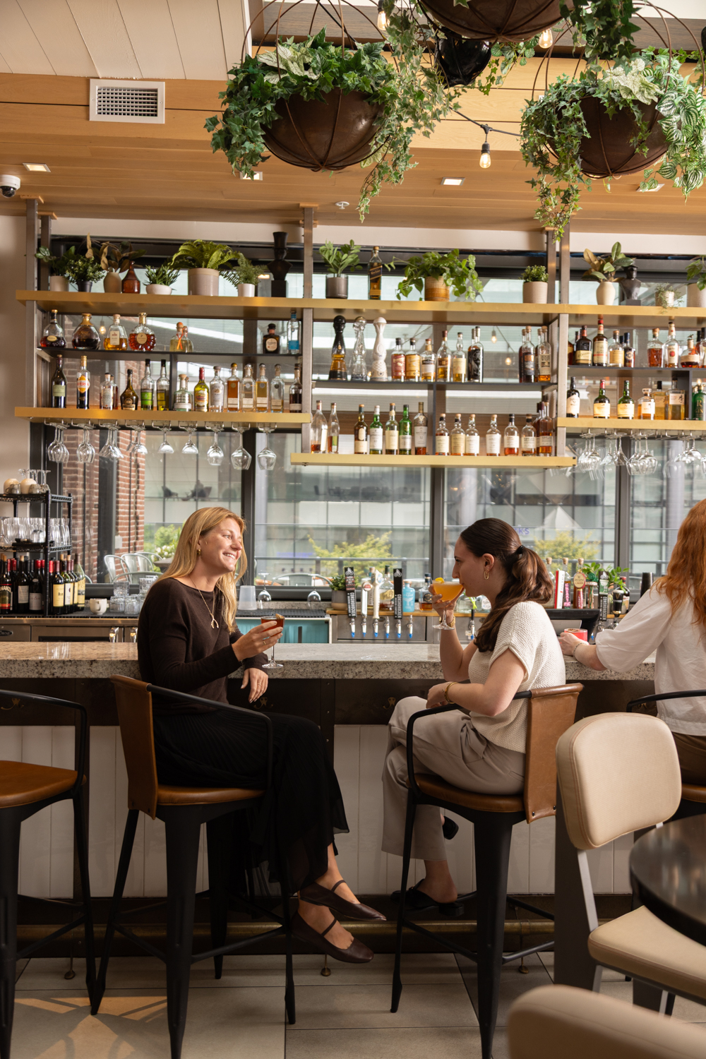 a group of women sitting at a bar