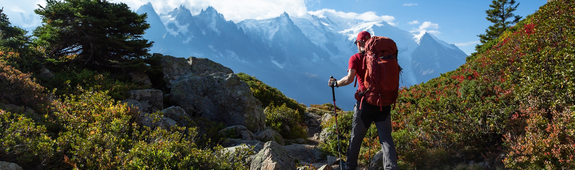 a woman standing at the top of a cliff