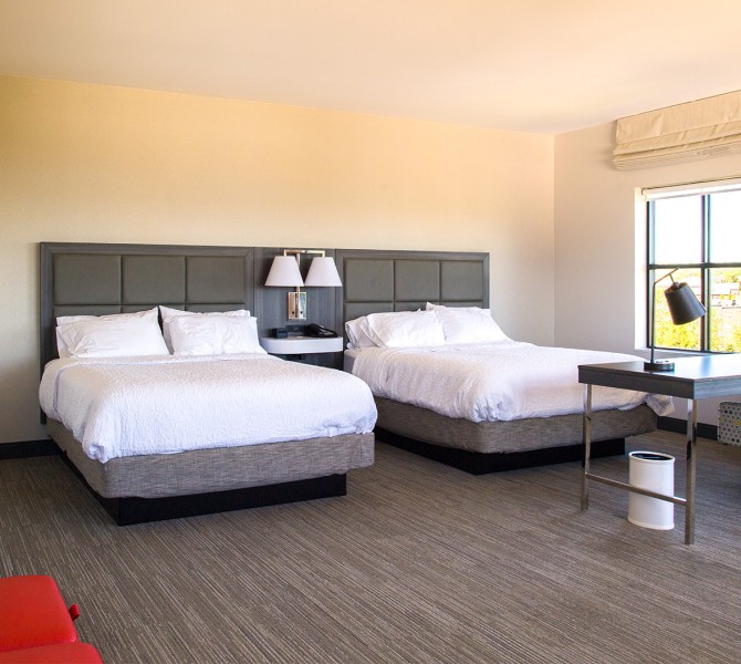 a room with two beds and a desk