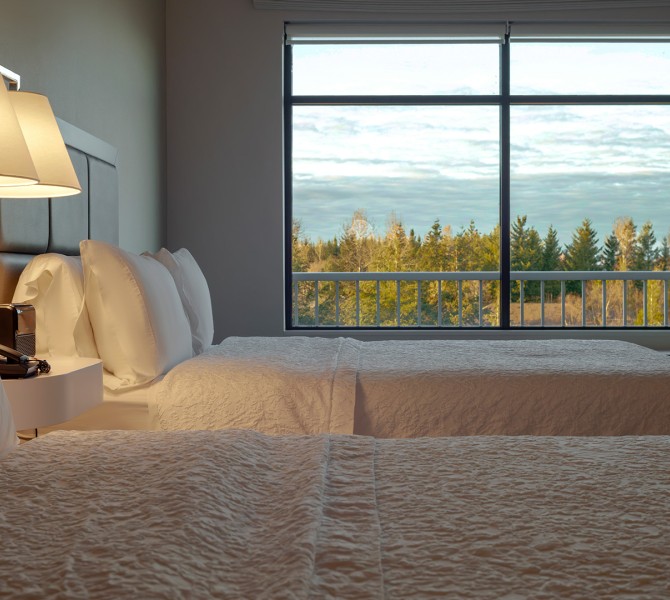 a room with two beds and a window