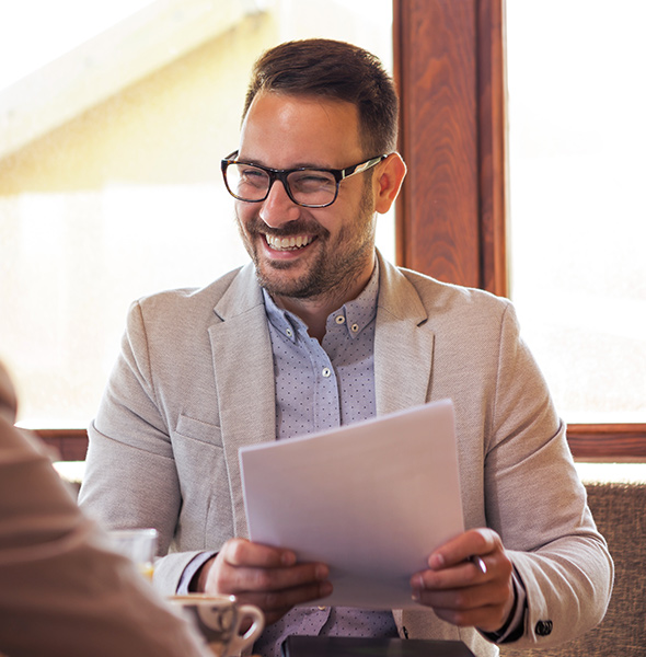 a man holding papers during a meeting