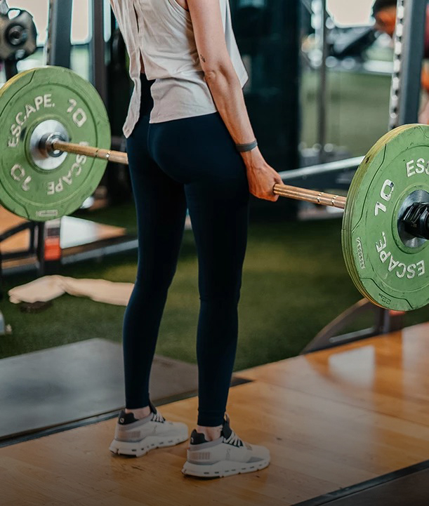 a woman lifting weights in a gym