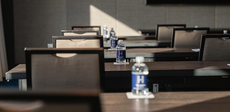 a group of chairs and a bottle of water on a table