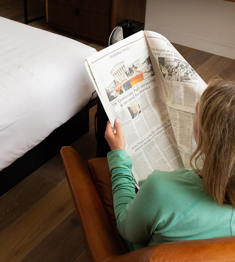a woman reading a newspaper