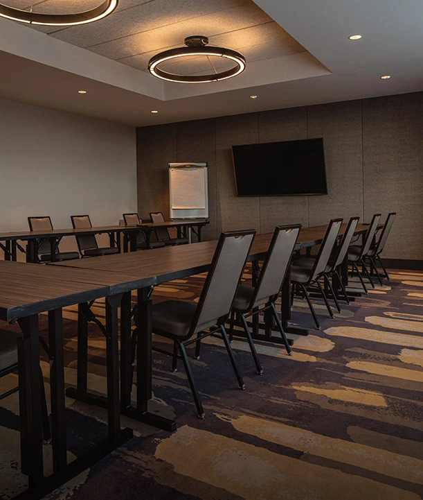 a room with a long table and chairs