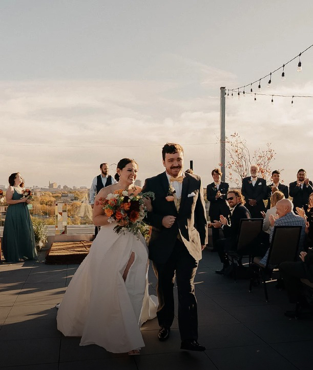 a man and woman walking down a rooftop