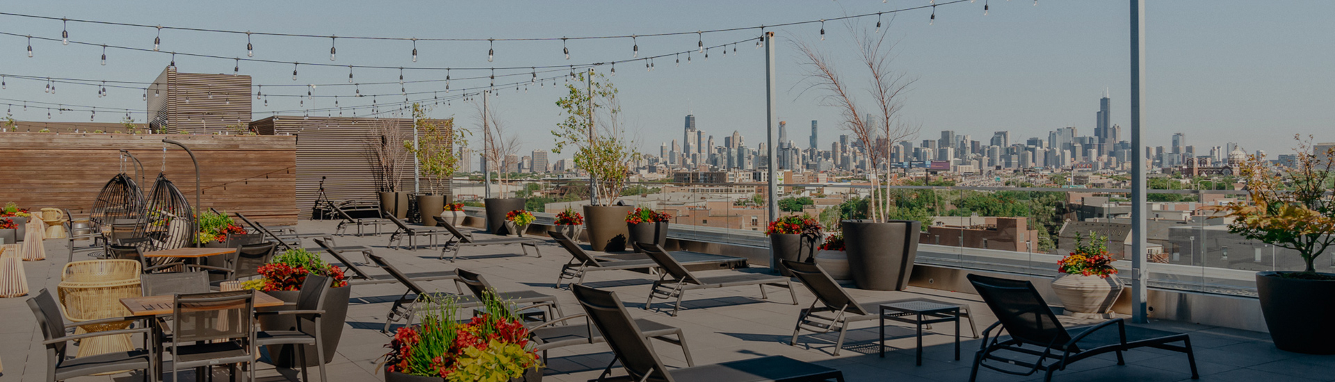 chairs on a rooftop with a city in the background