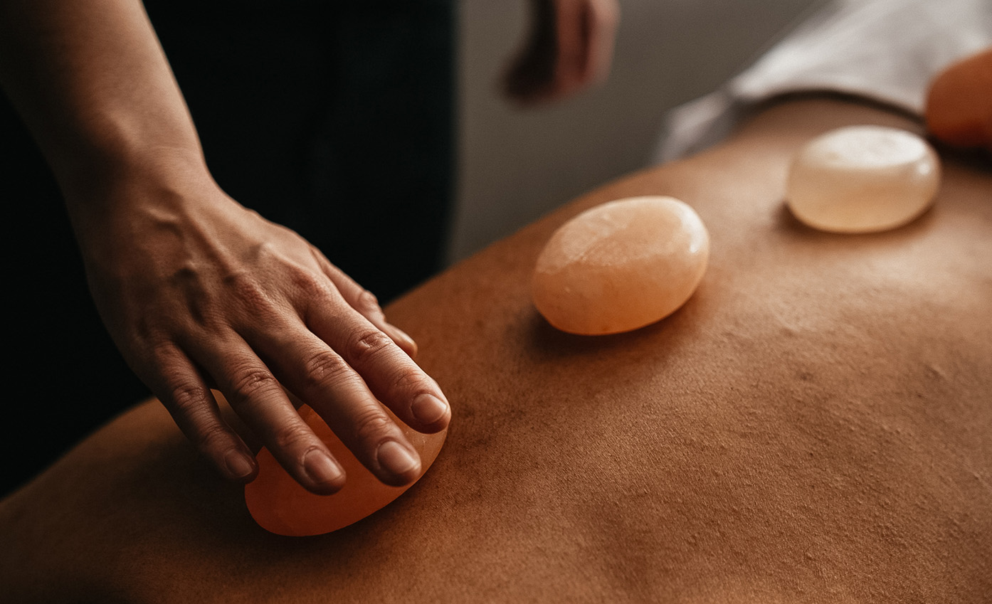 a person's back with a stone on it