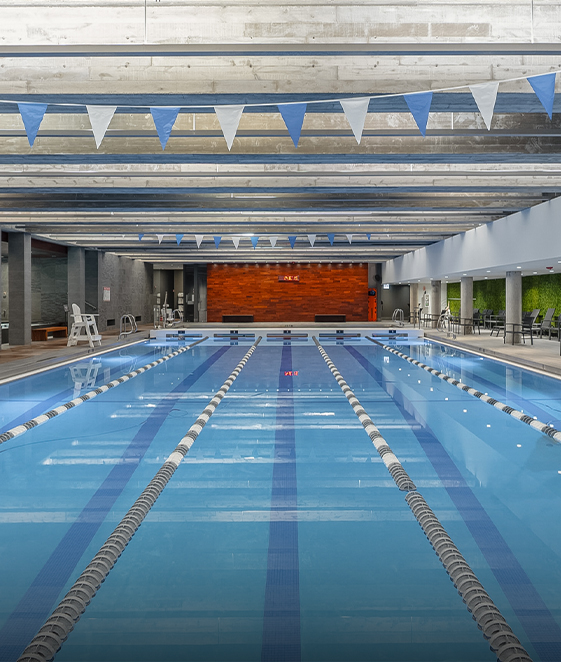 a swimming pool with flags from ceiling